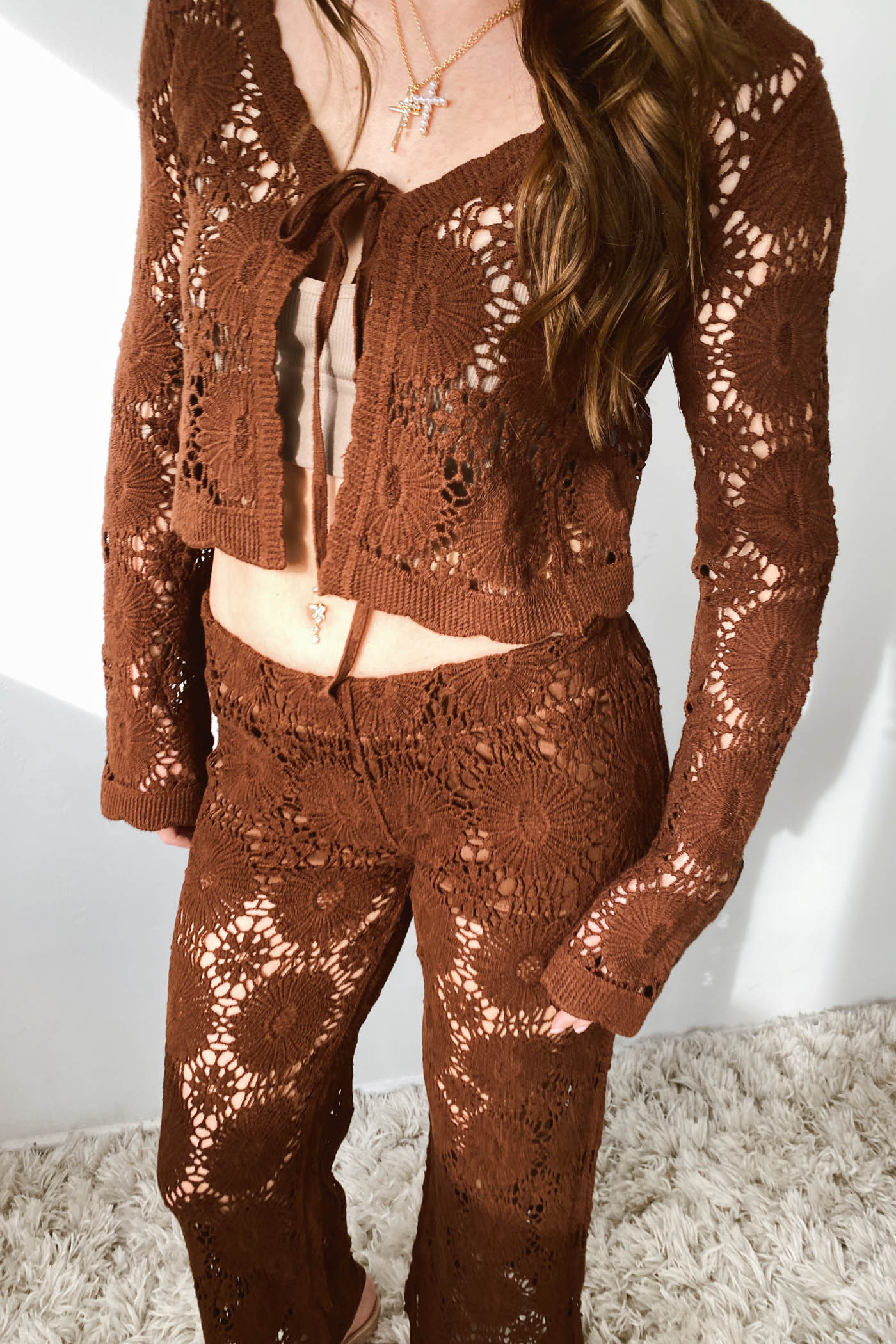 Brown crochet outfit worn by a person on a neutral background