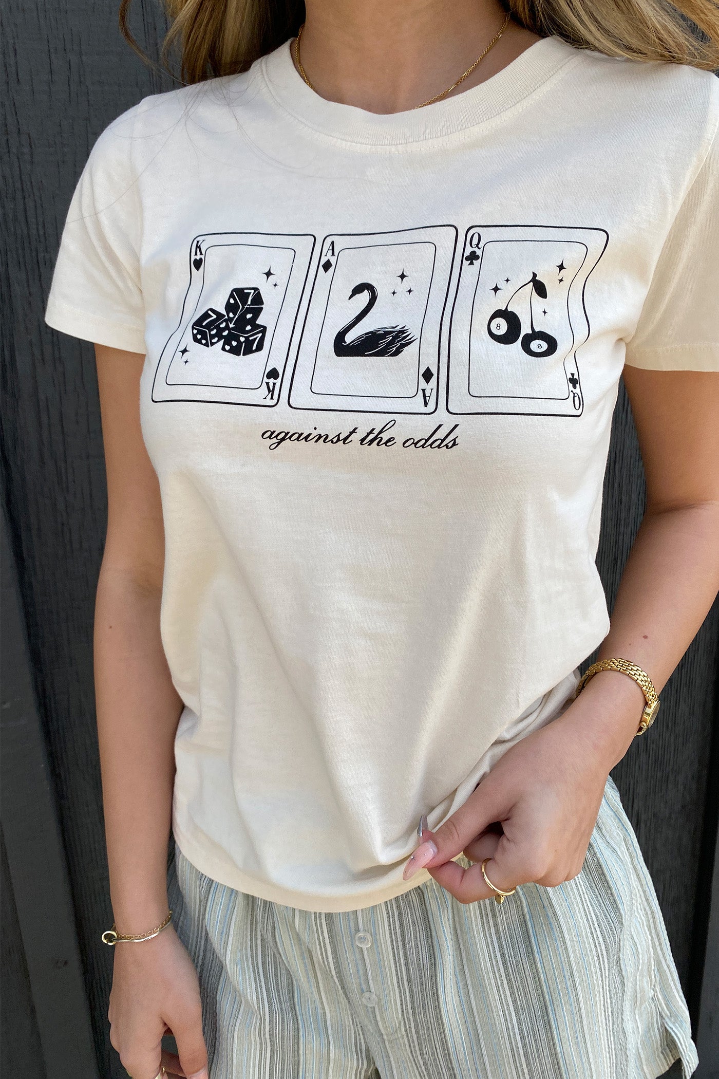 Against The Odds Long Line Graphic Baby Tee