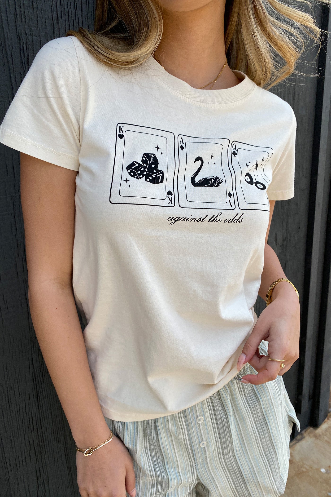Against The Odds Long Line Graphic Baby Tee