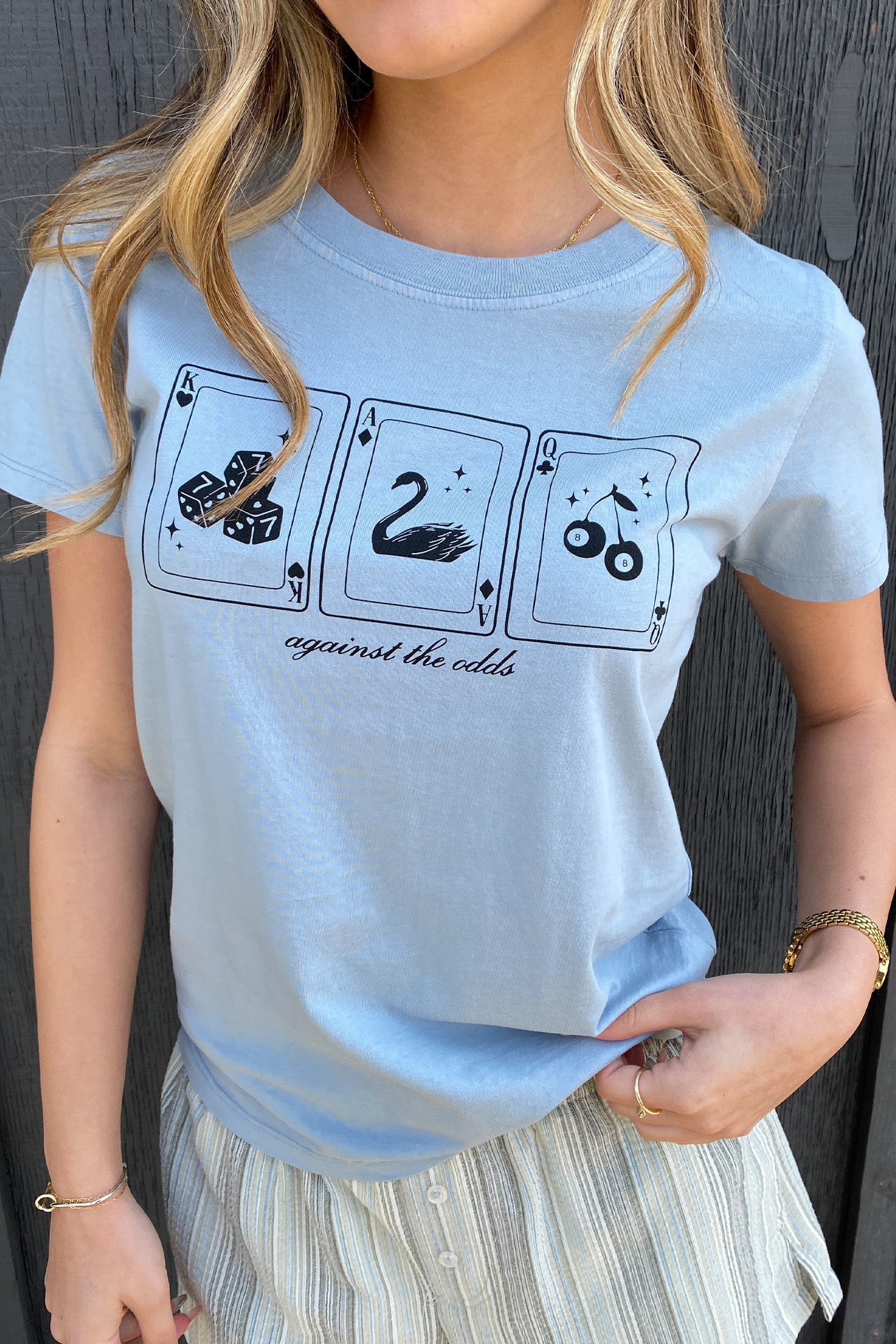 Against The Odds Long Line Graphic Baby Tee