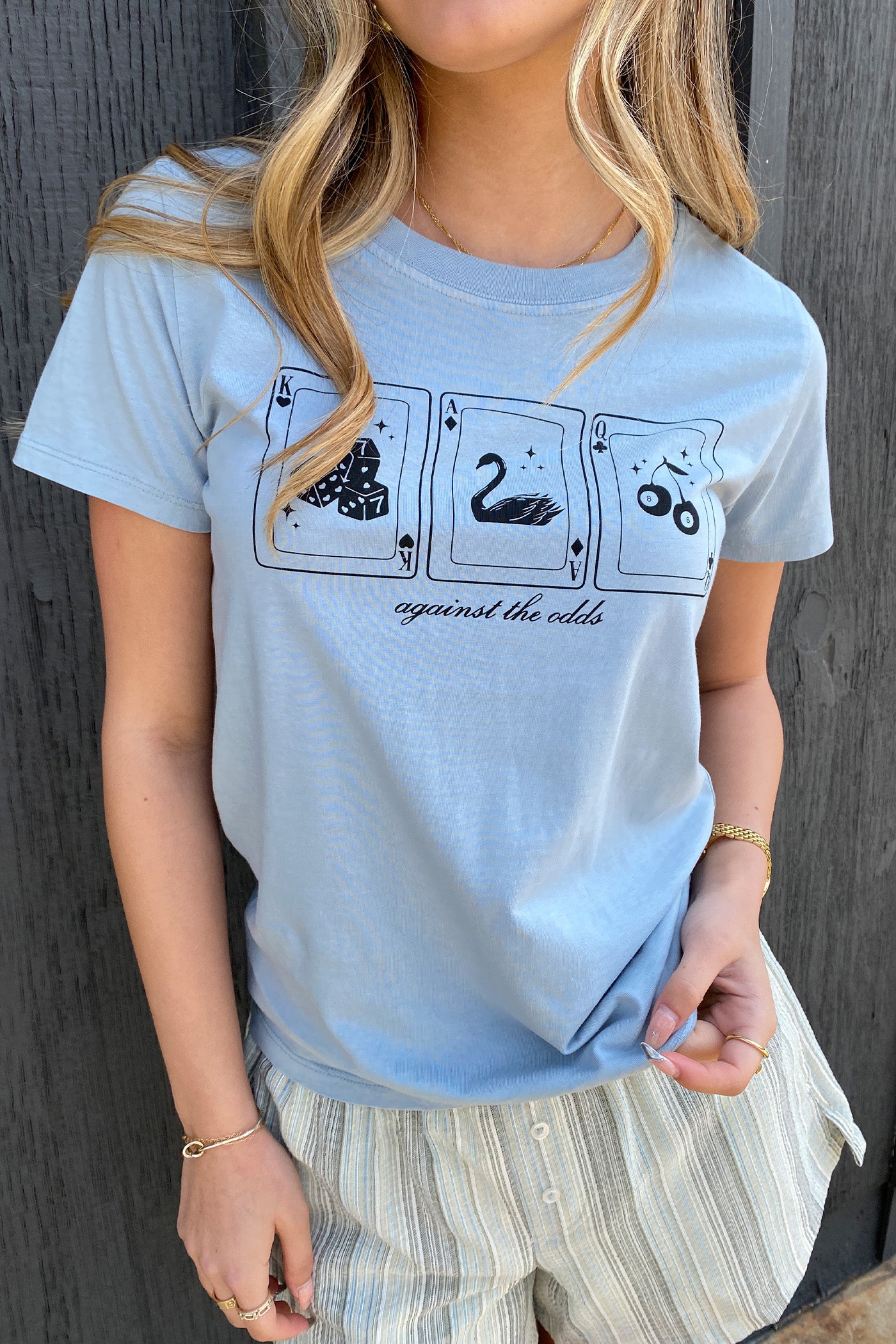 Against The Odds Long Line Graphic Baby Tee