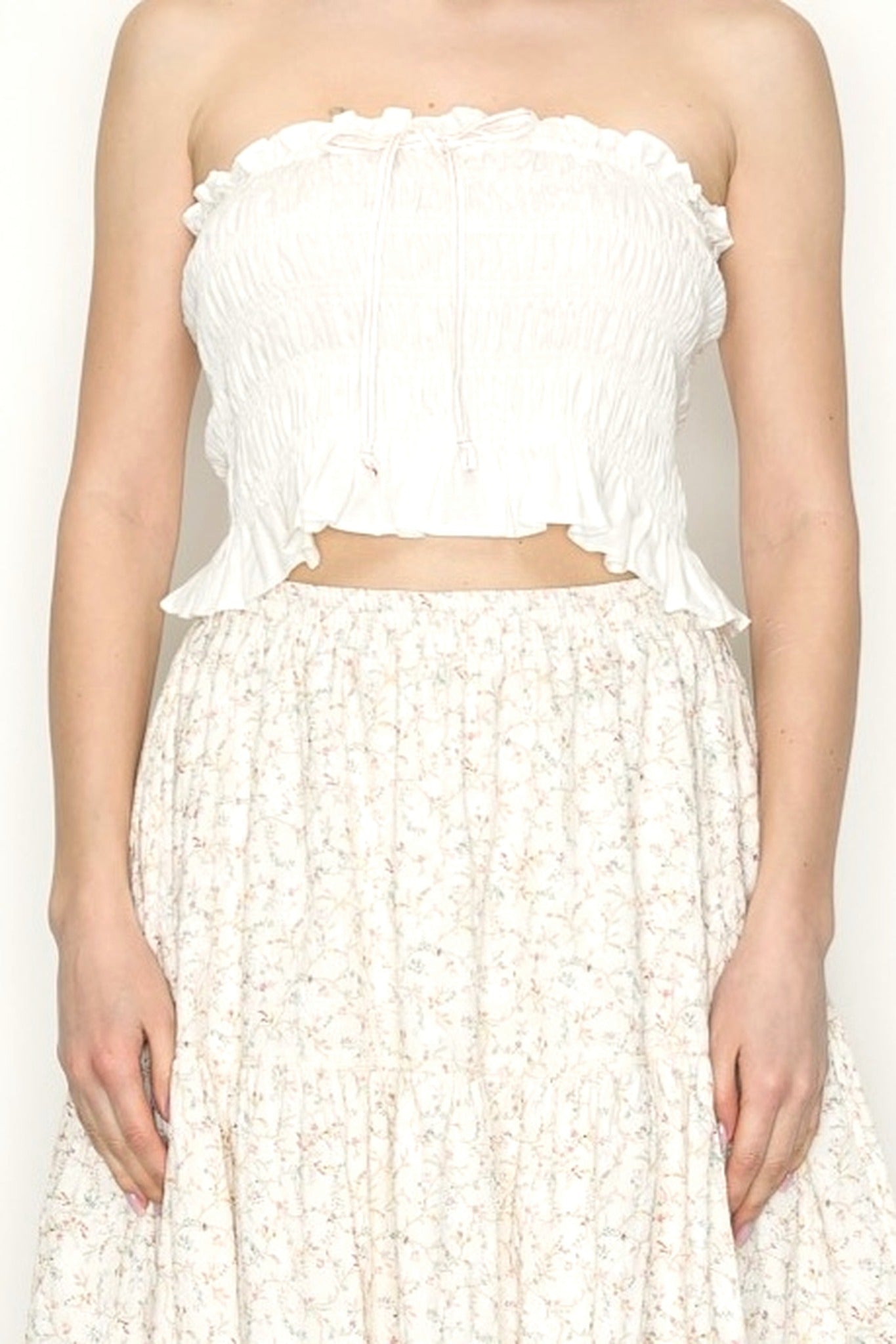 White strapless top and skirt set on a plain background