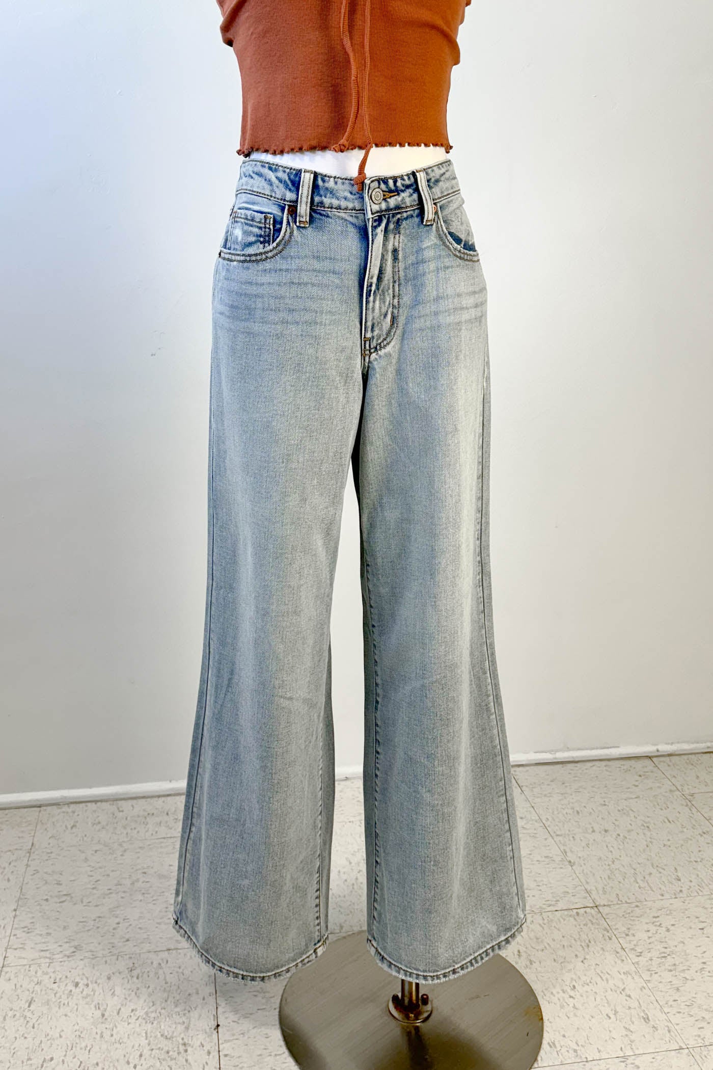 Light blue jeans on a mannequin against a white background