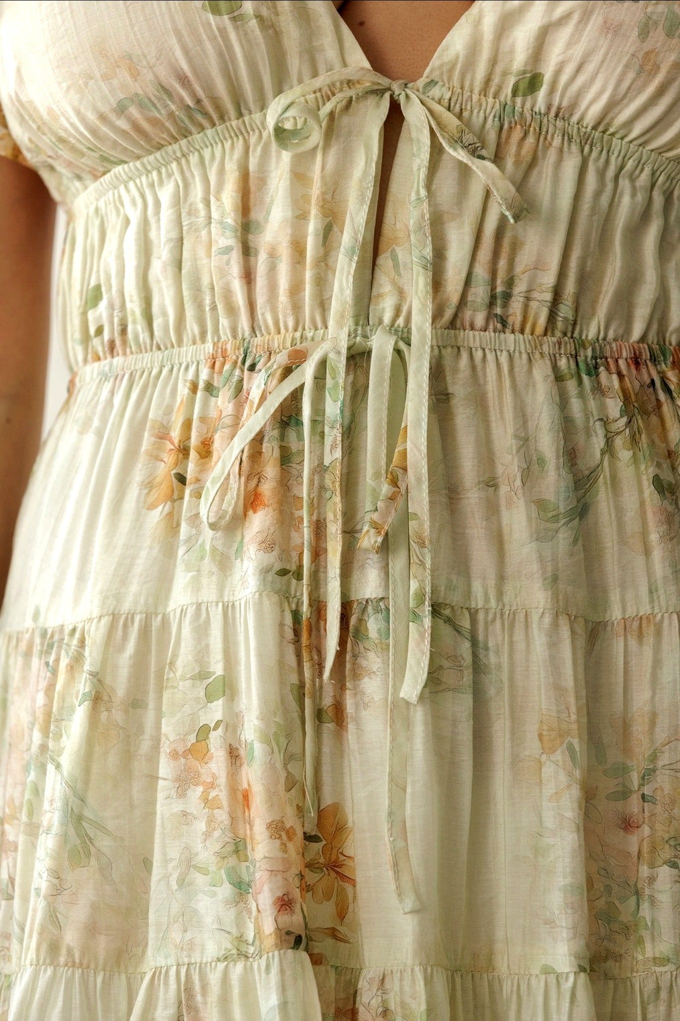 Floral dress with tiered layers on a neutral background