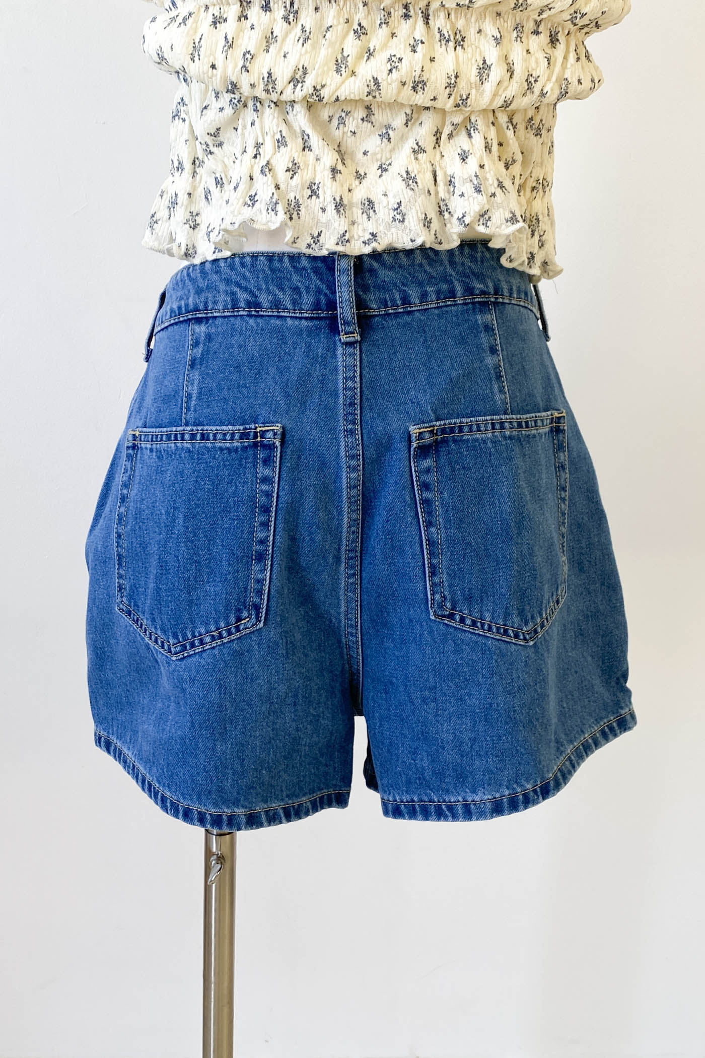 Blue denim Skort on a mannequin against a white background