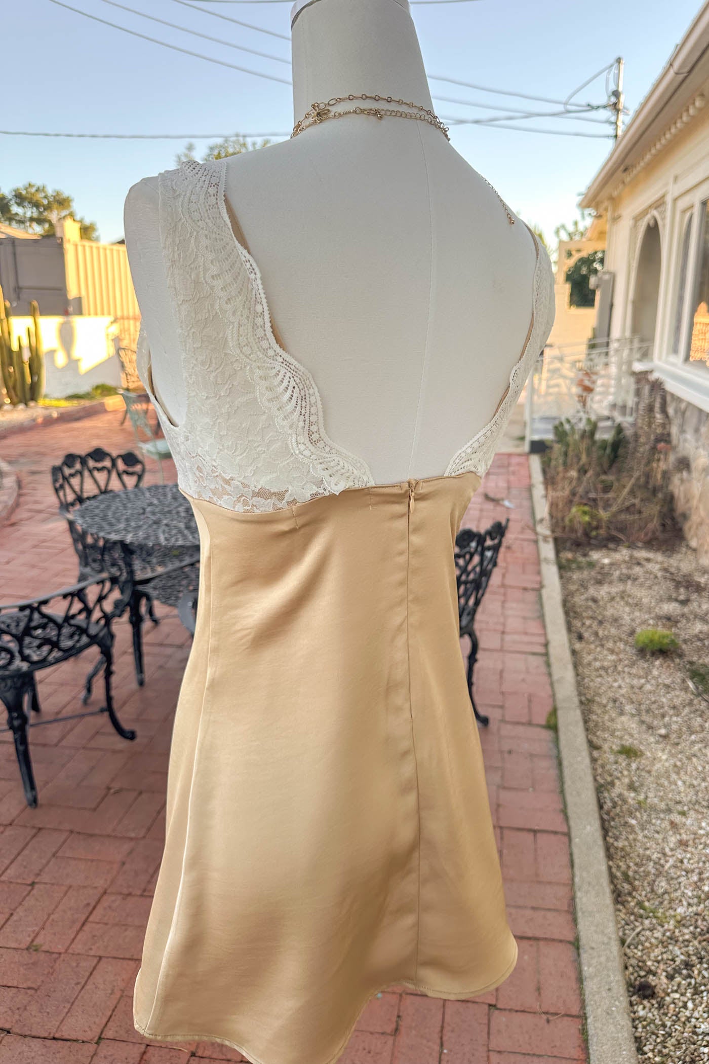 Mannequin wearing a yellow lace trim mini dress.