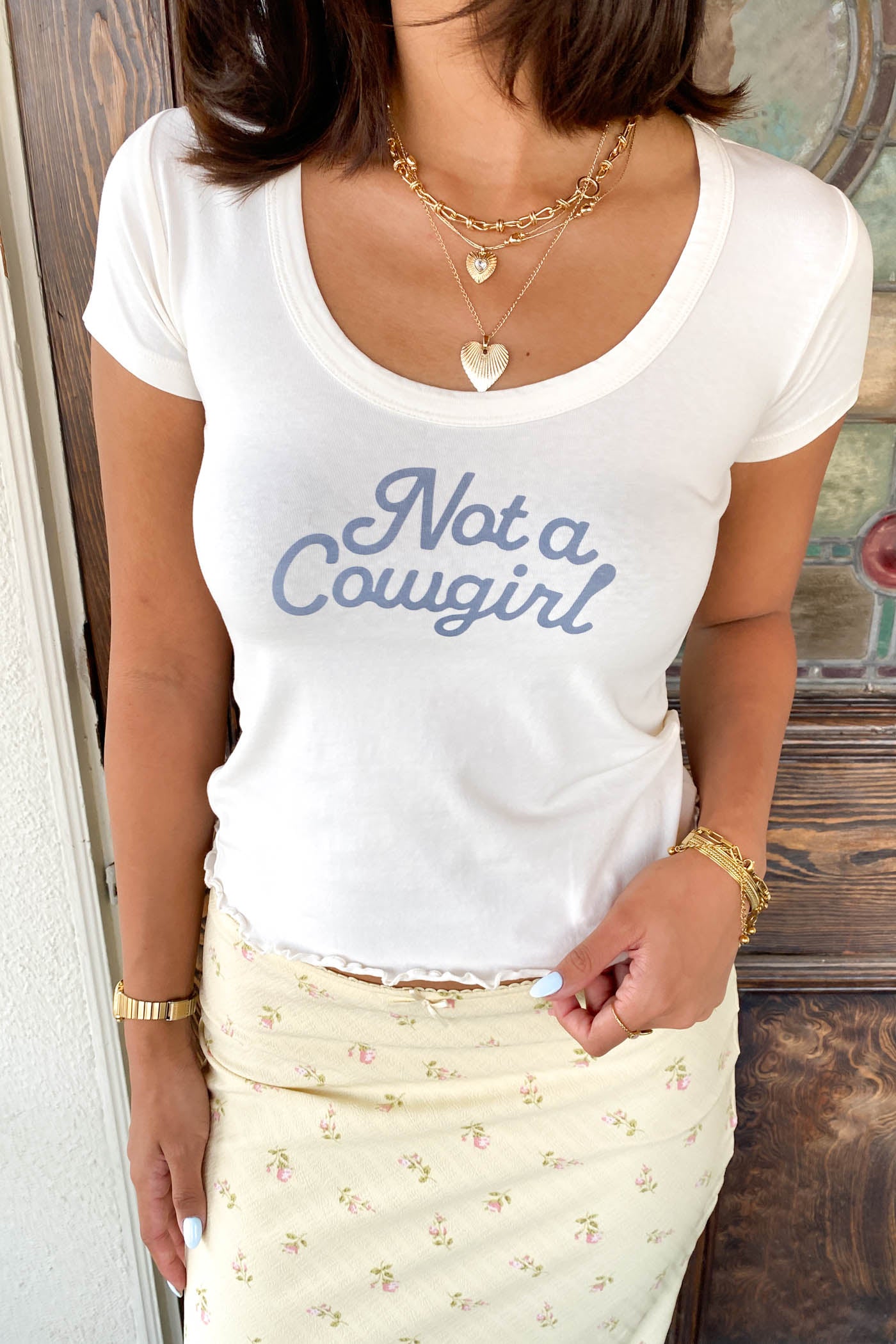 Not A Cowgirl Scoop Neck Graphic Baby Tee