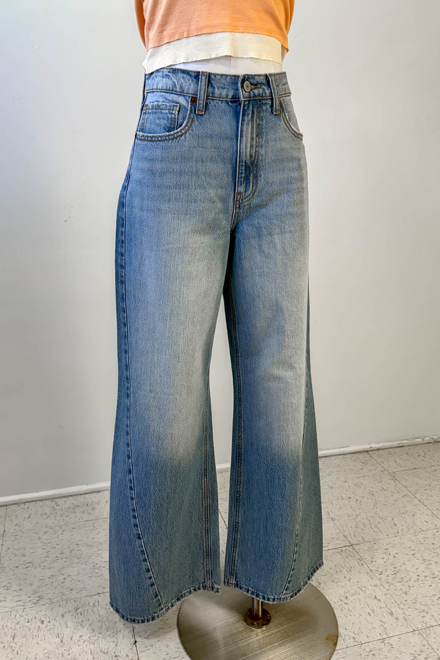 Blue jeans on a mannequin against a white background