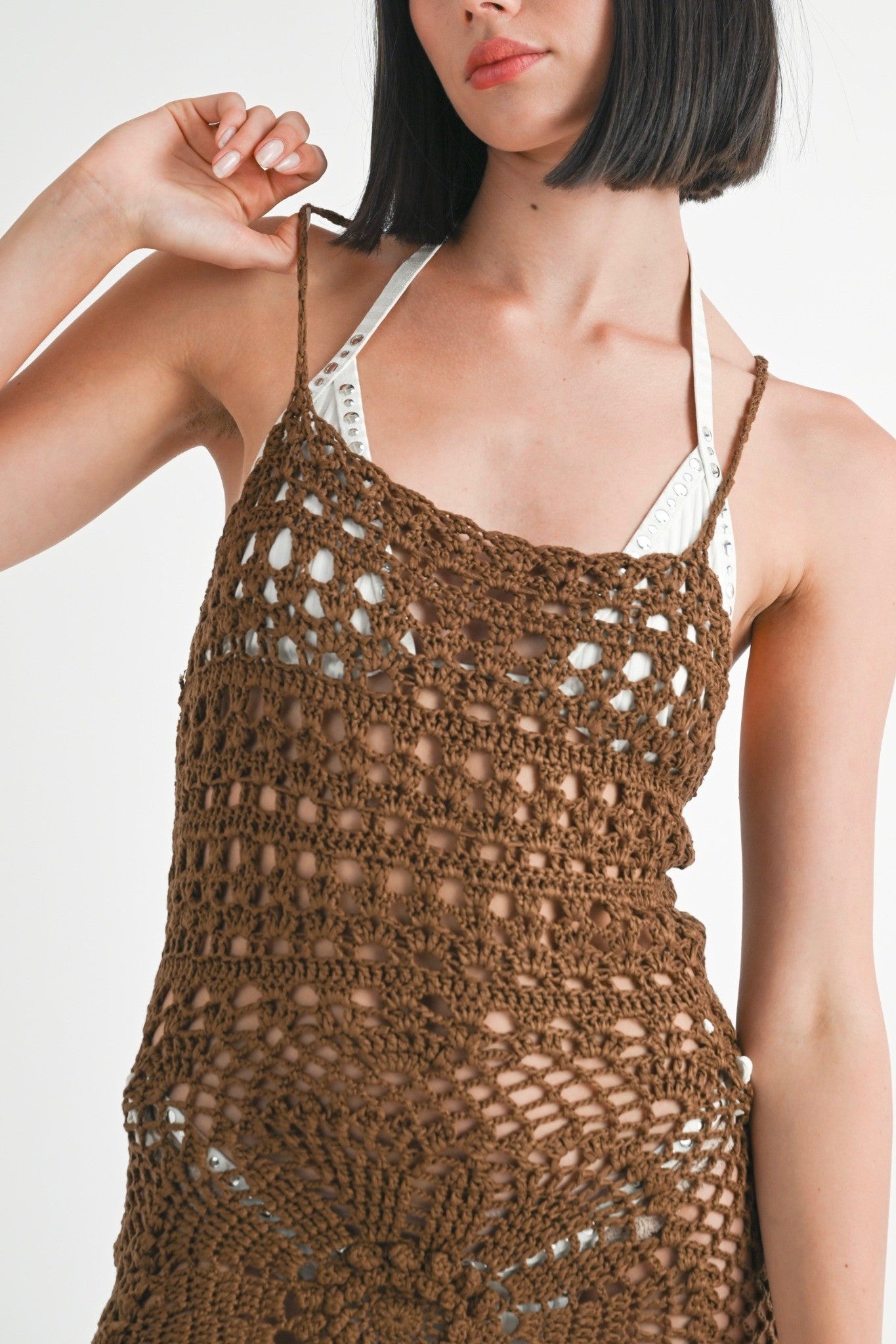 Brown crochet dress worn by a model on a white background