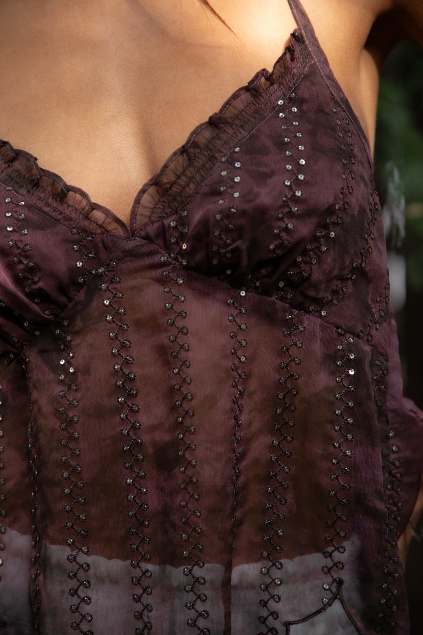 Close-up of a dark purple dress with intricate detailing