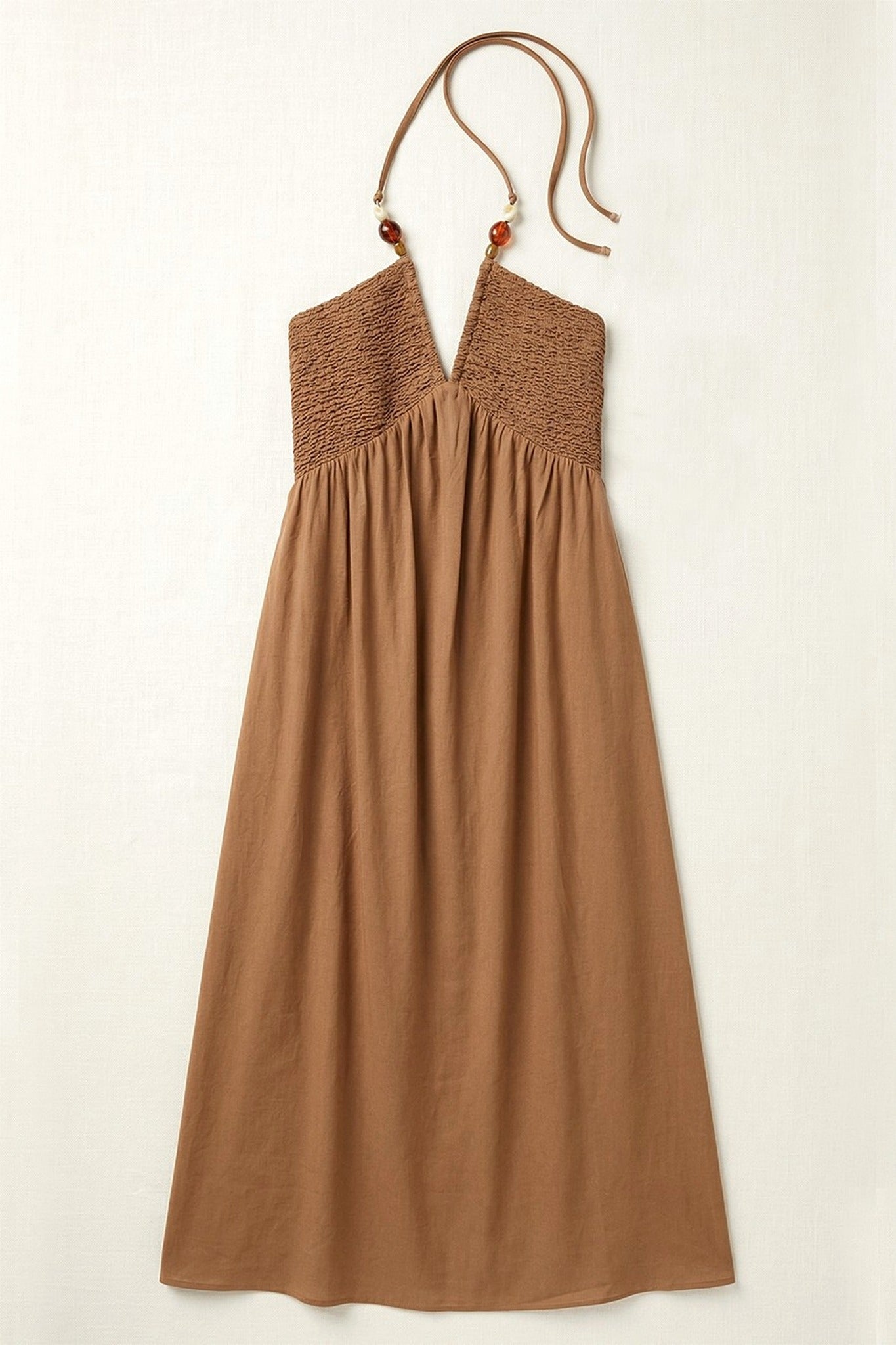 Brown halter neck dress on a white background