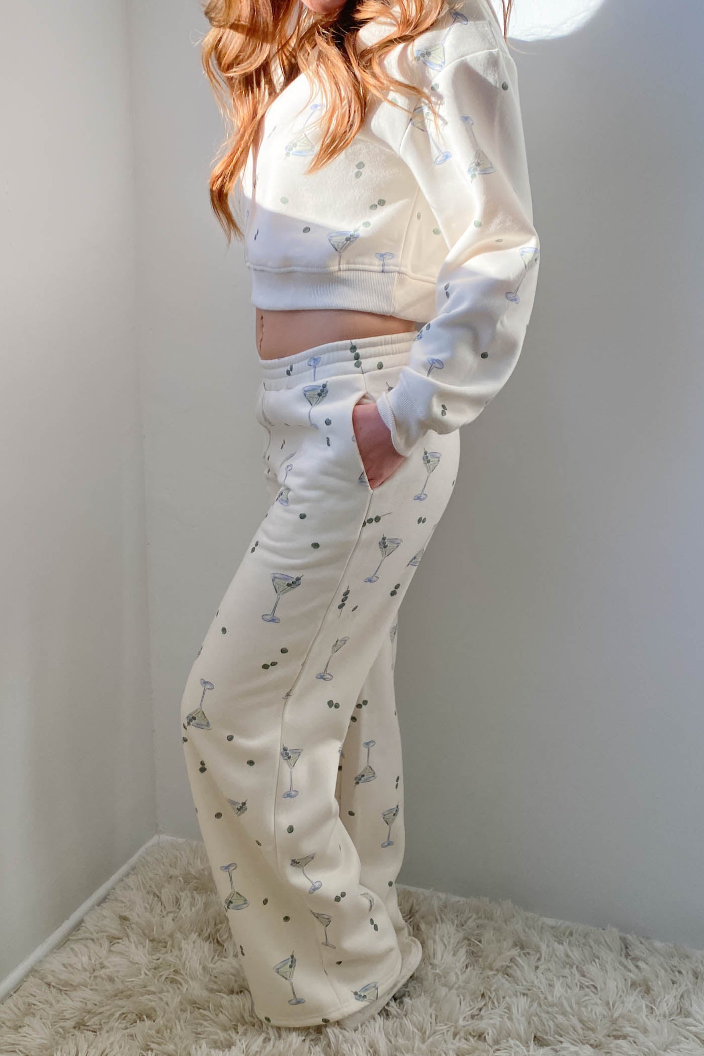 Person wearing a white pajama set with small patterns on a light background