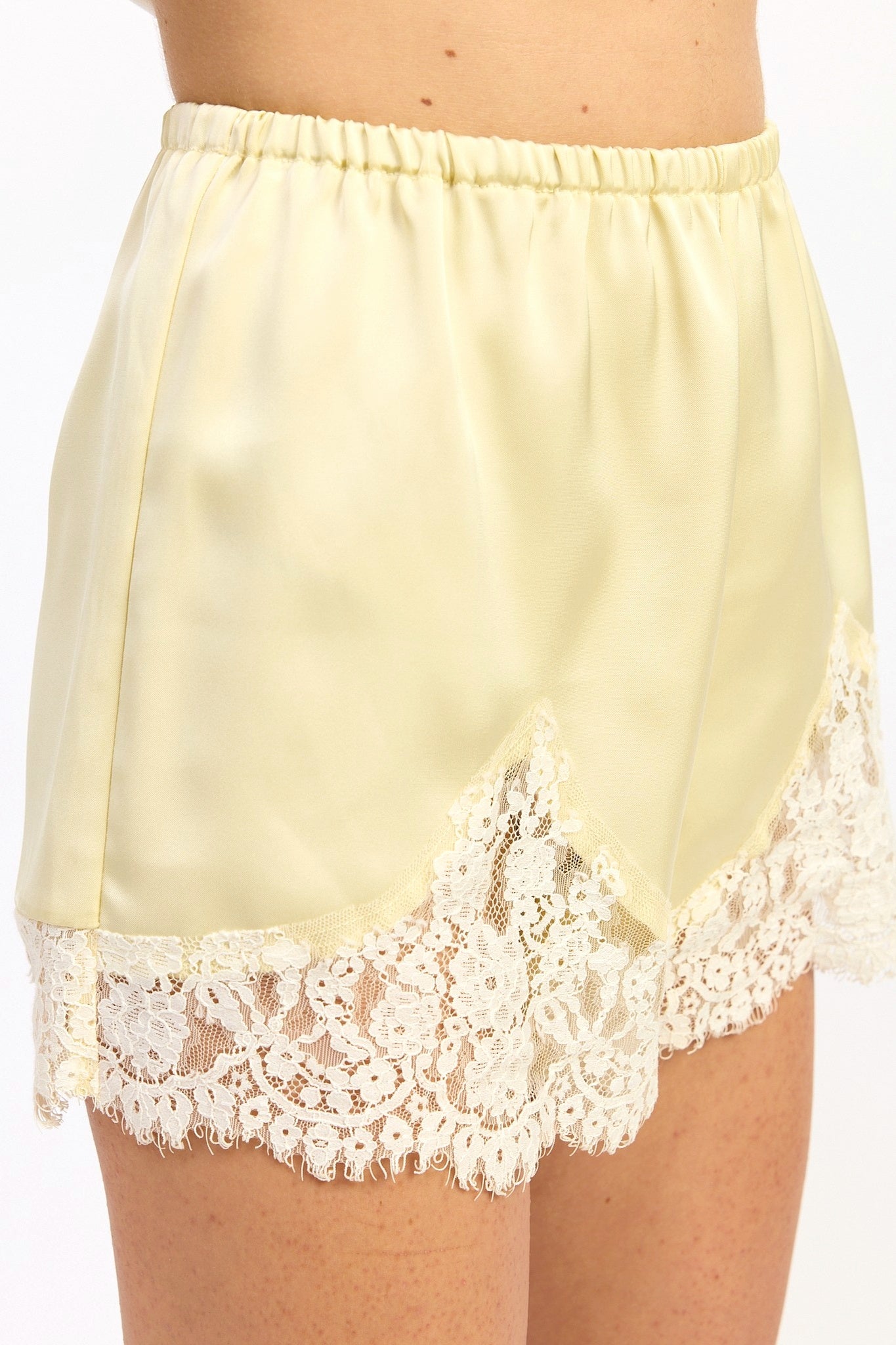 Light yellow satin nightgown with lace trim on a white background