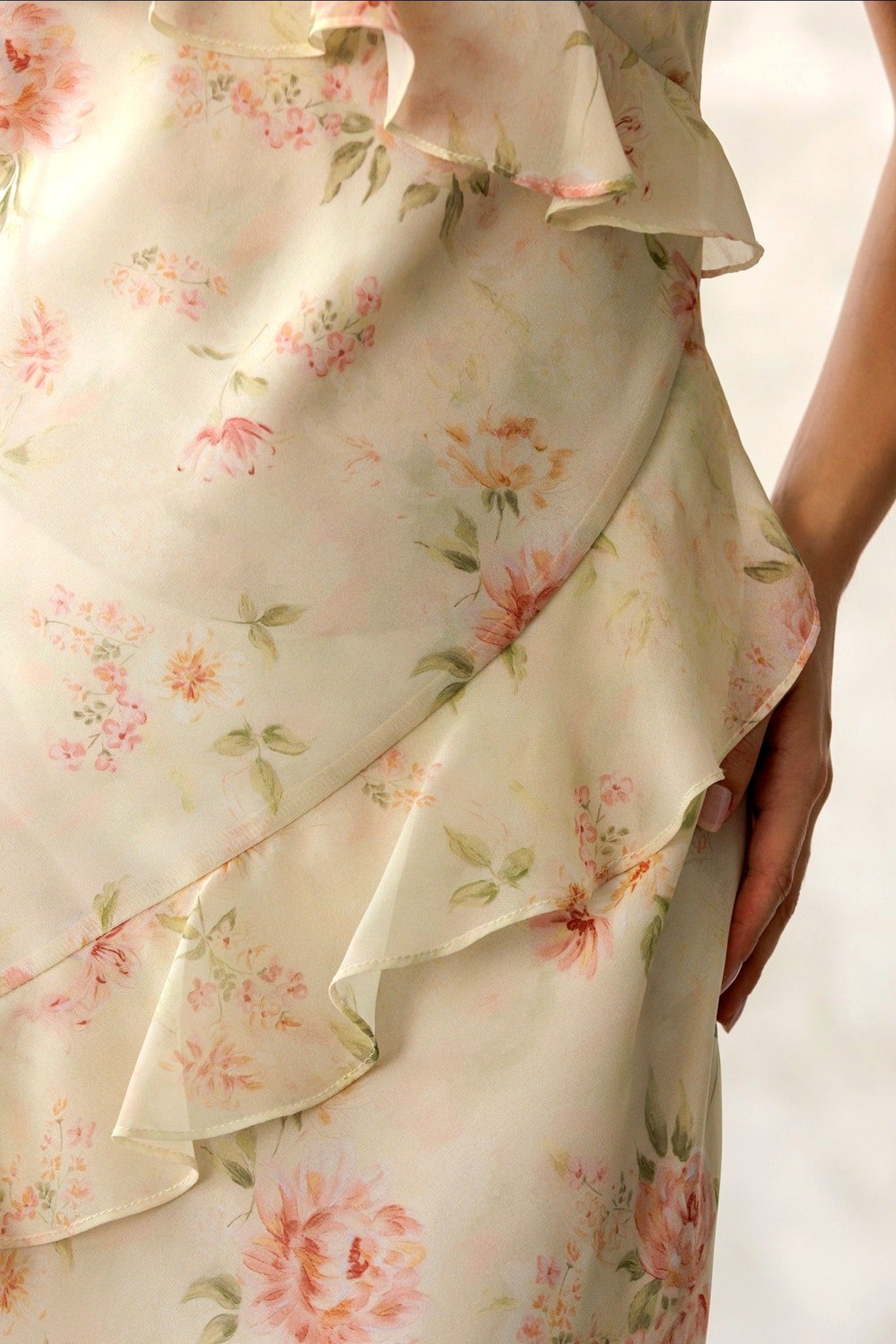 Floral dress with ruffled layers on a plain background