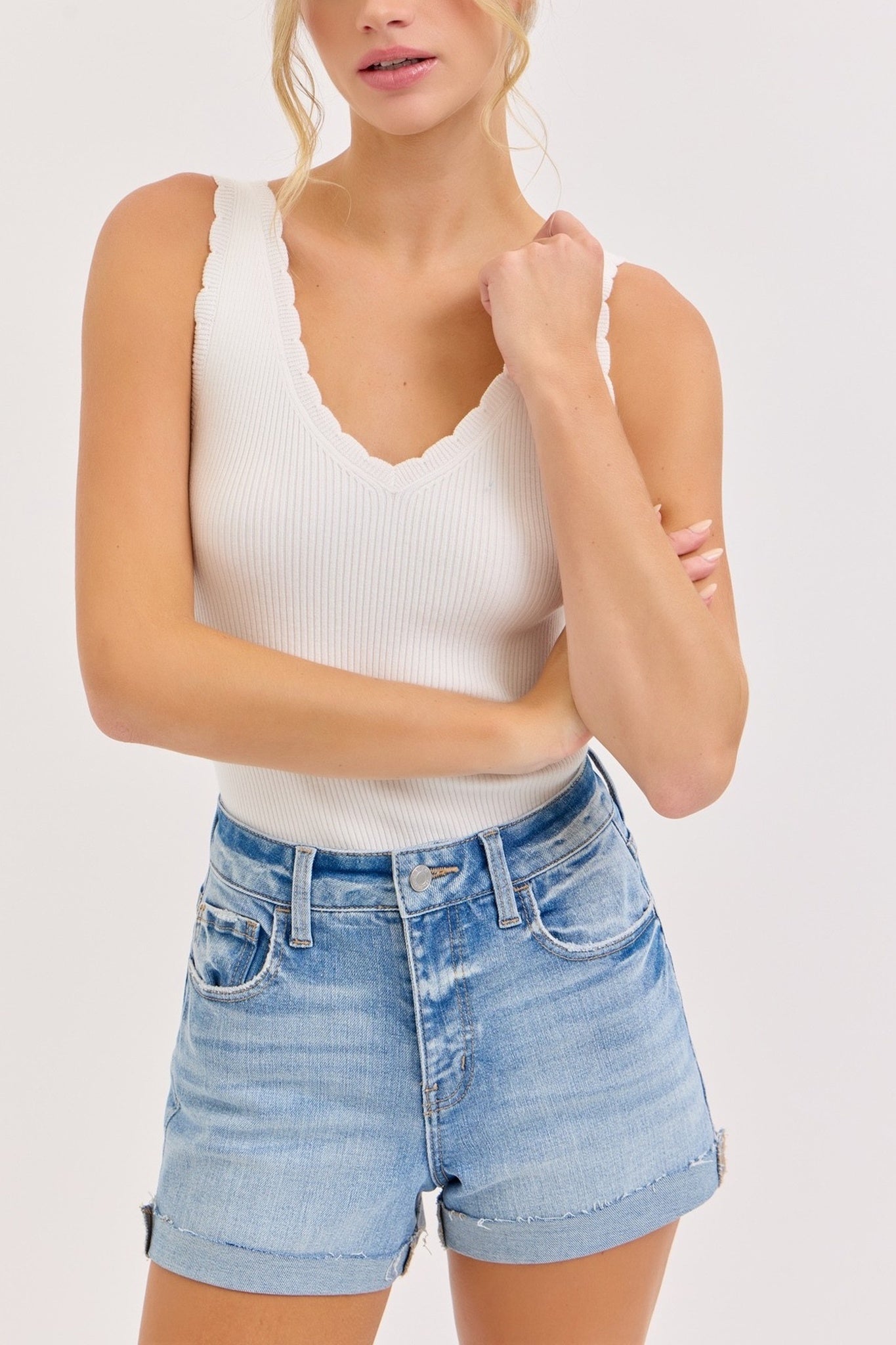 Light blue denim shorts worn by a person on a white background