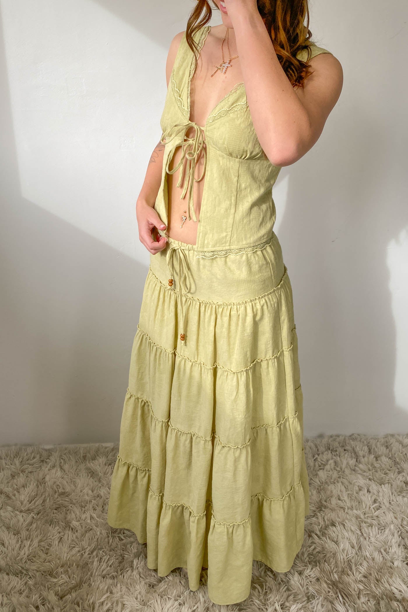 Woman wearing a light green dress with a white background