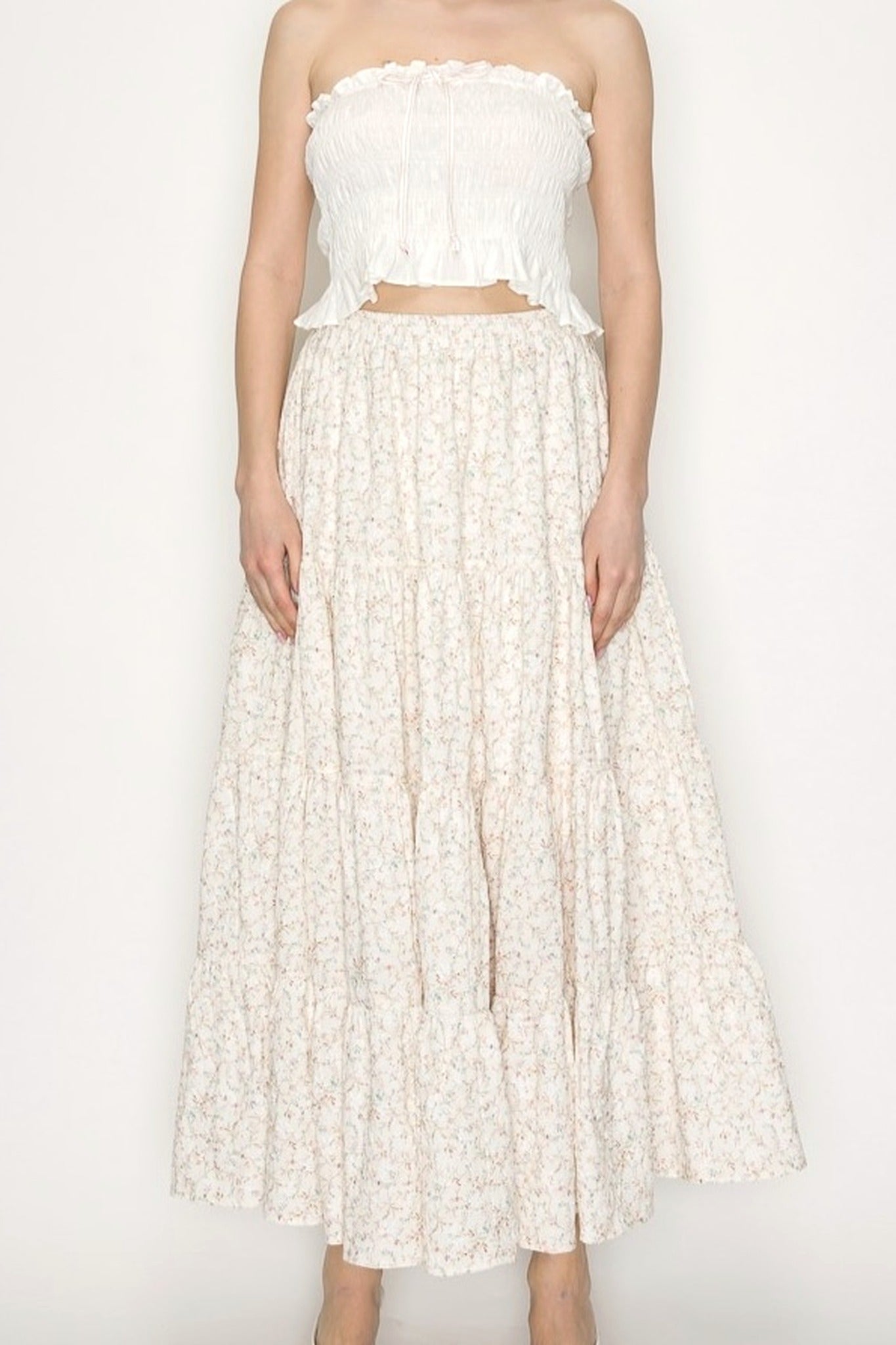Cream Floral Midi Skirt on Model Standing against blank wall. 