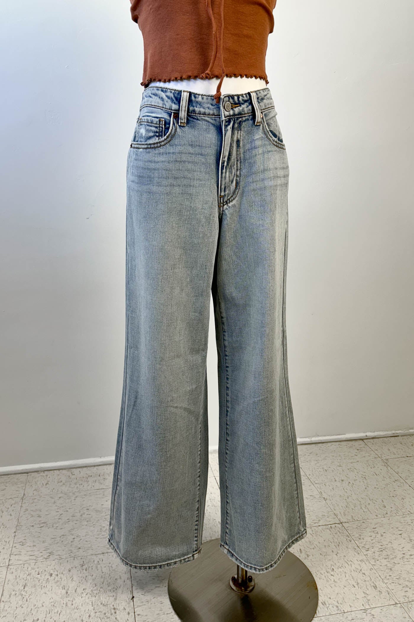 Light blue wide-leg jeans on a mannequin against a plain background