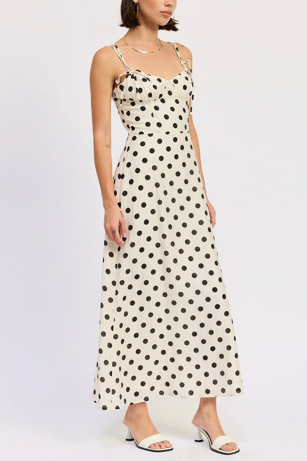 Woman wearing a polka dot dress on a white background