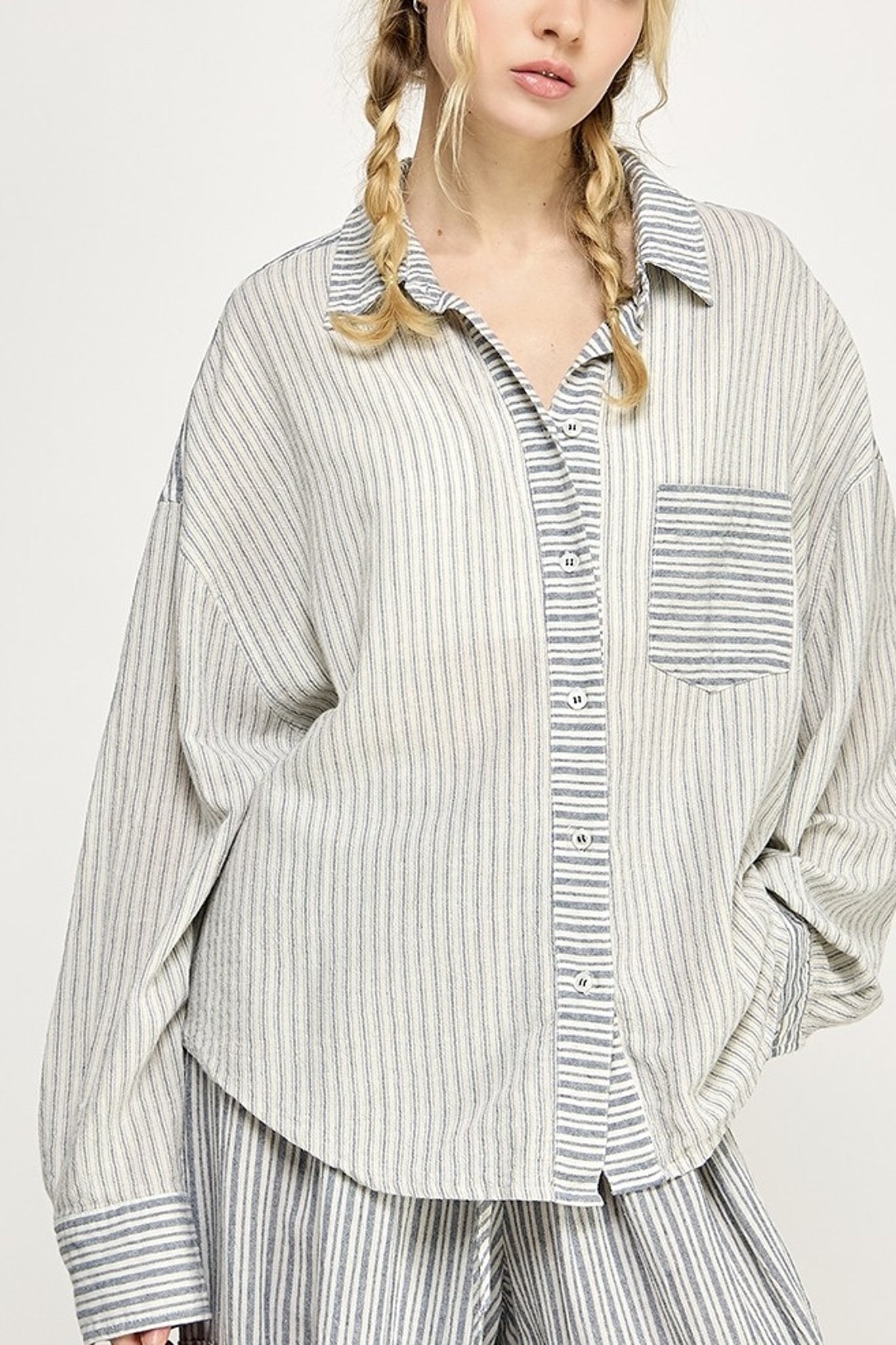 Person wearing a striped shirt with a white background