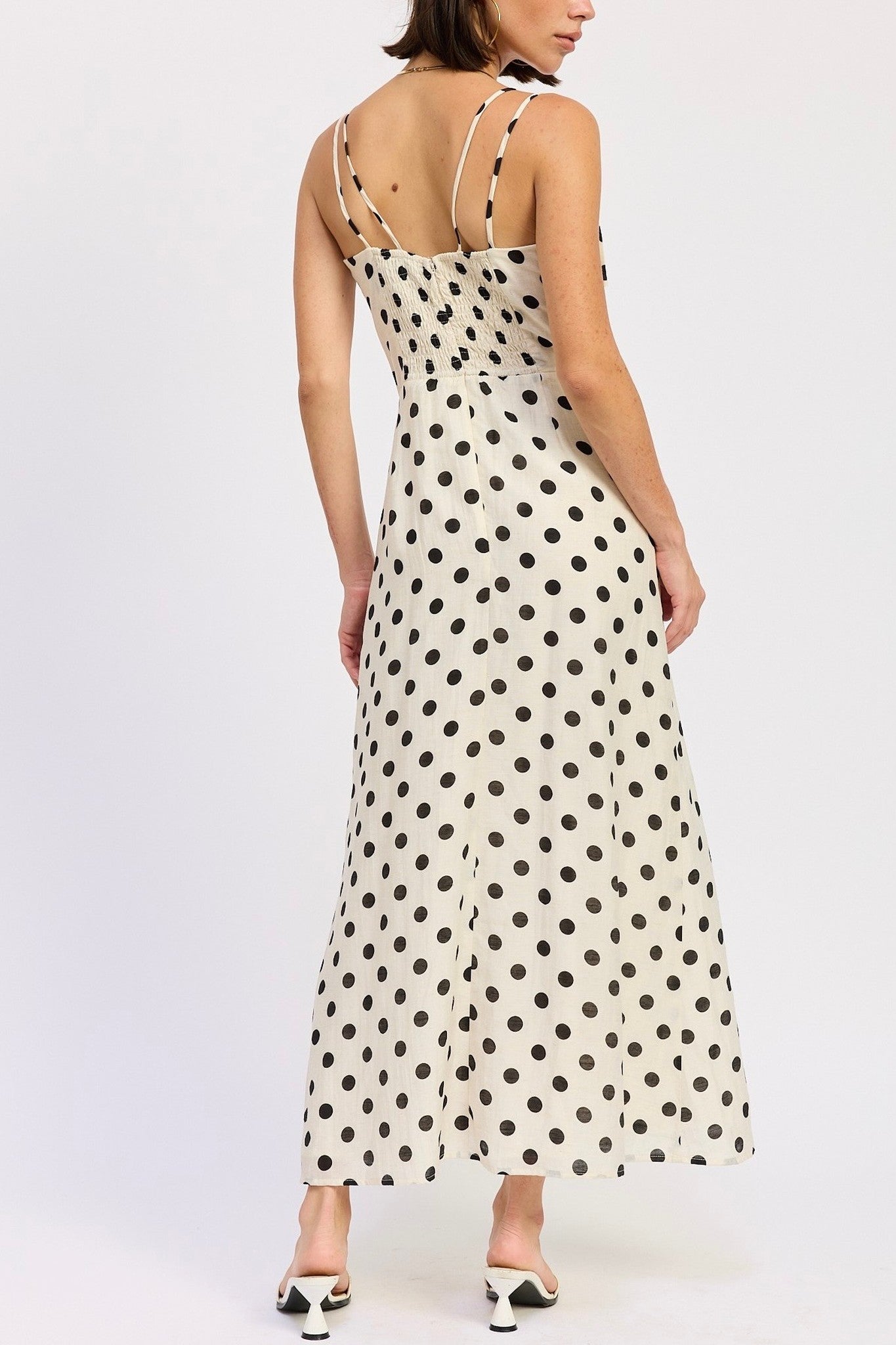 Woman wearing a polka dot dress on a white background