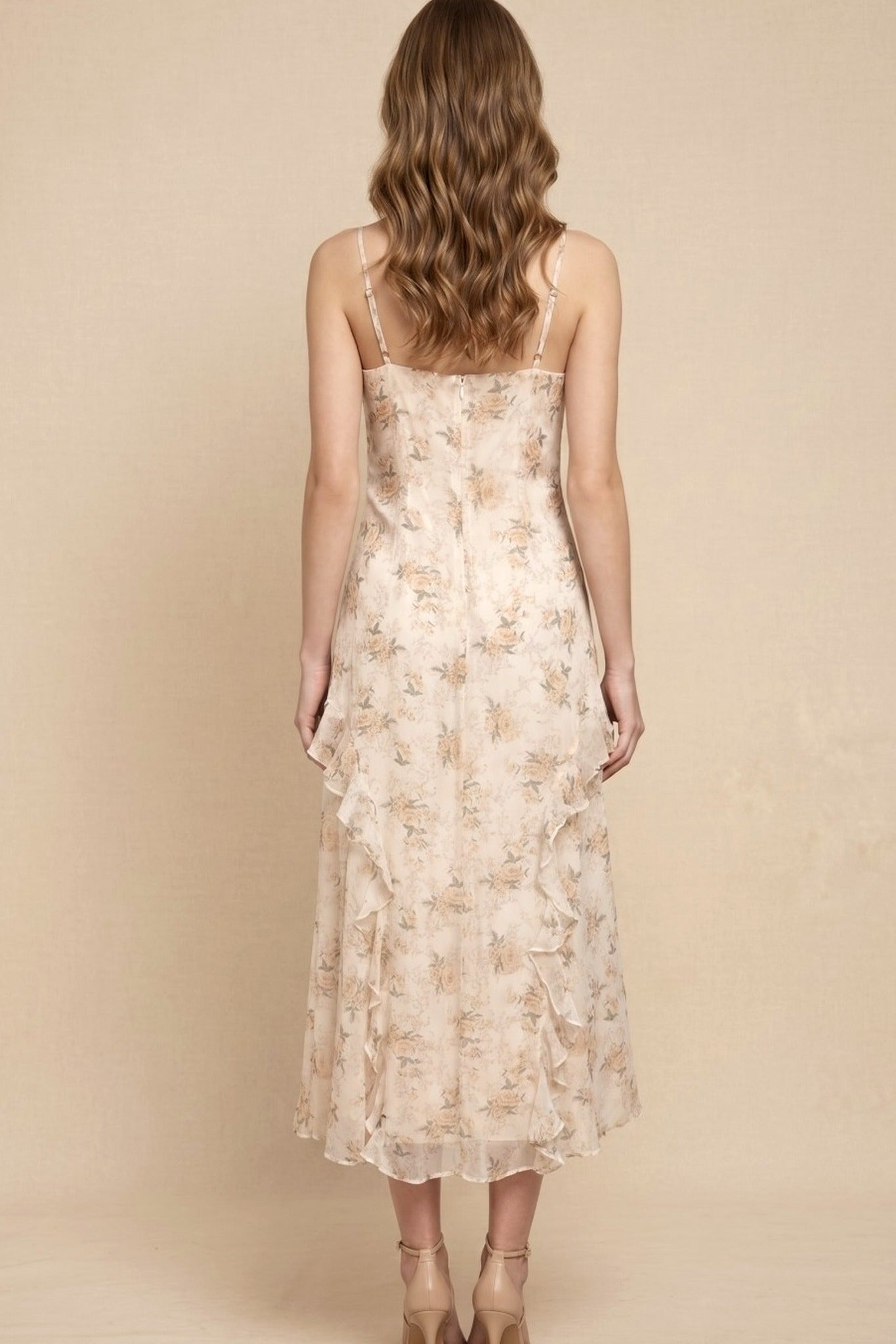 Woman wearing a floral dress against a beige background