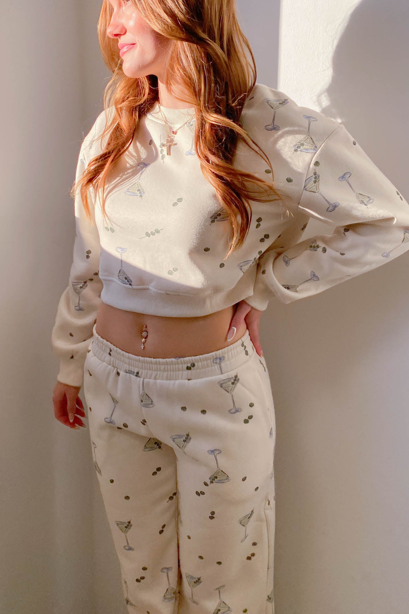 Person wearing a matching pajama set with a light pattern against a plain background