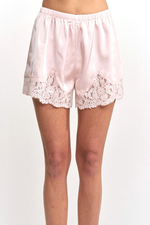 Pink satin shorts with lace trim on a white background