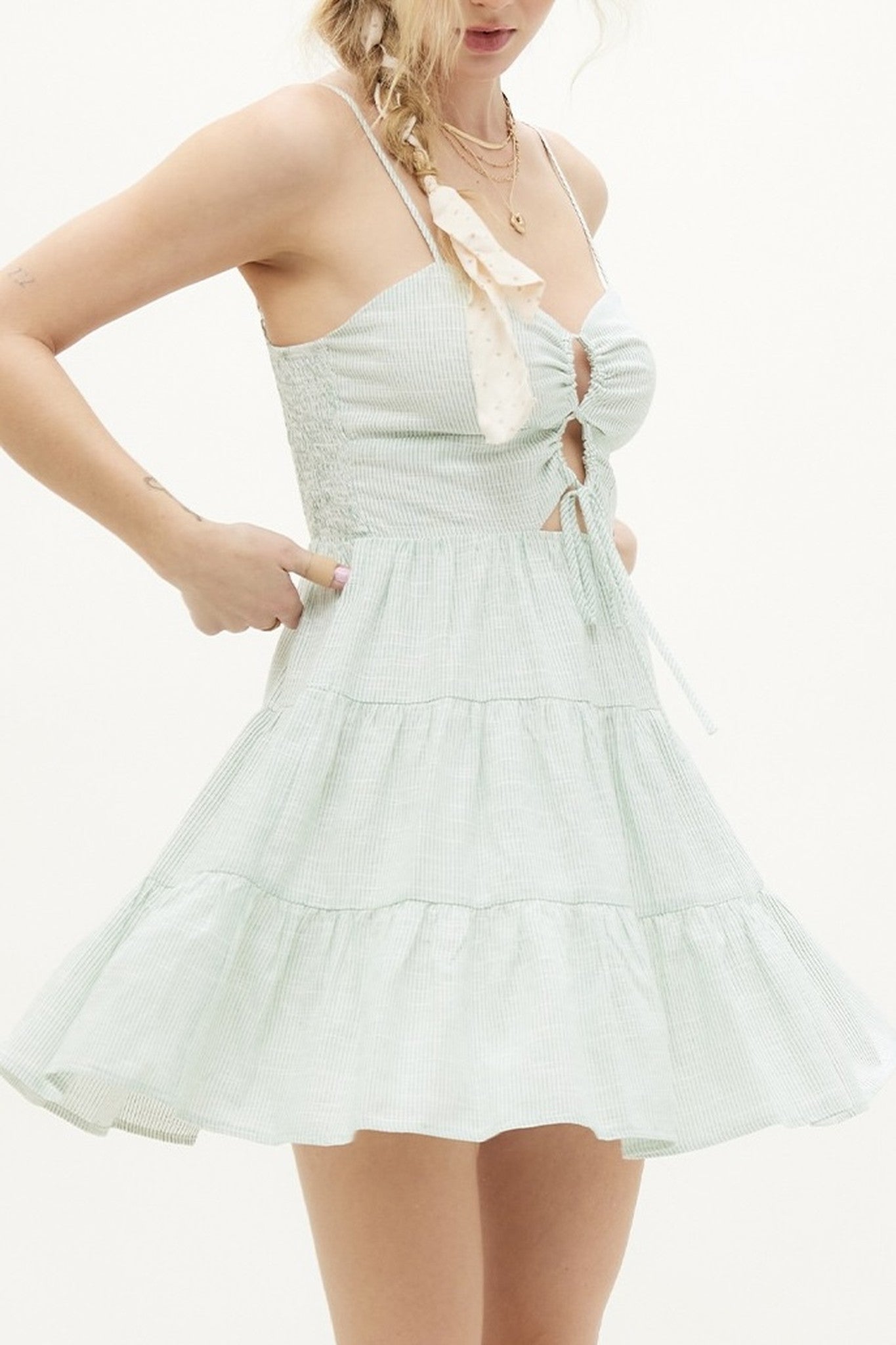 Light blue dress with thin straps worn by a person on a white background