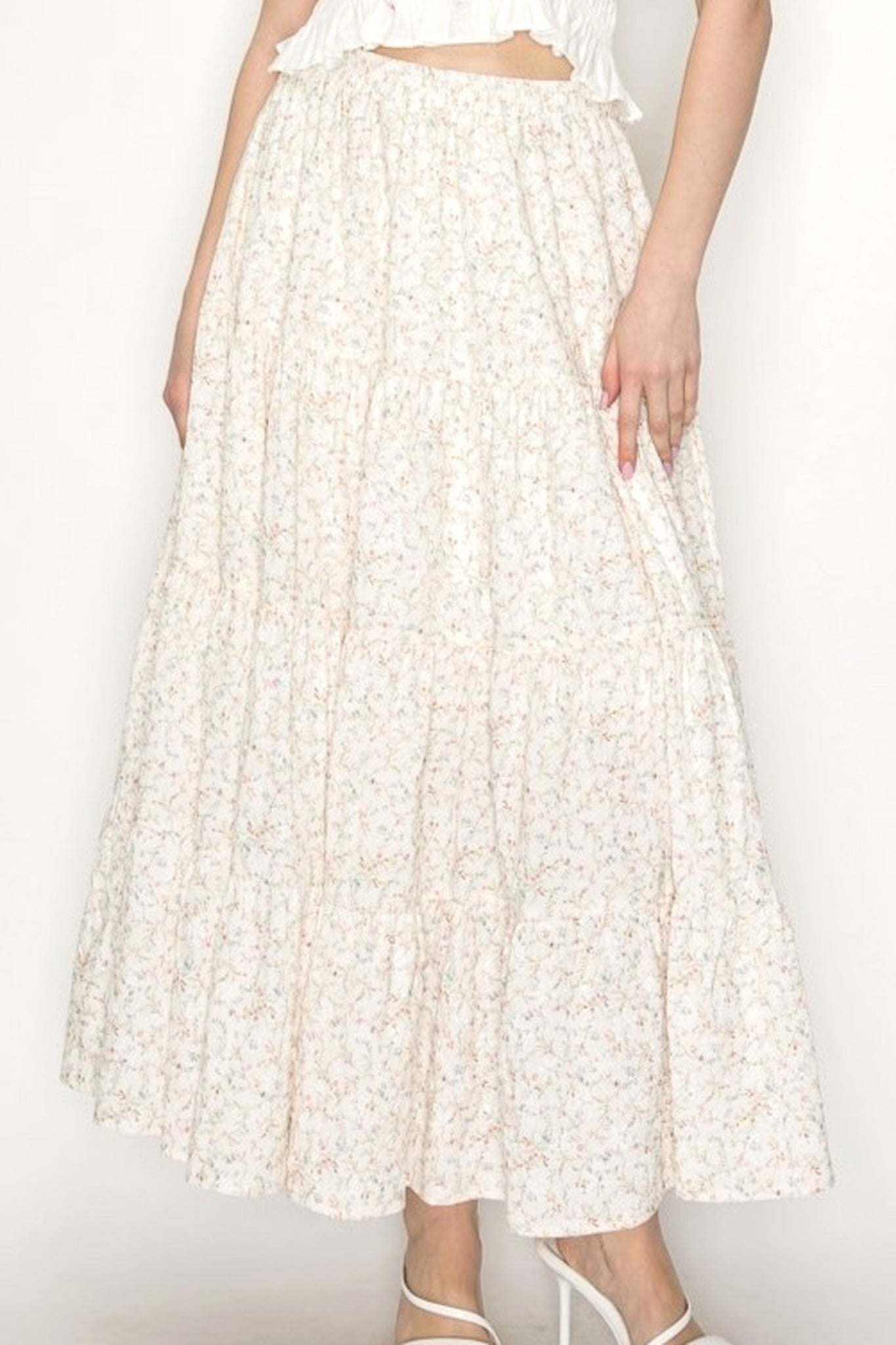 Cream Floral Midi Skirt on Model Standing against blank wall. 