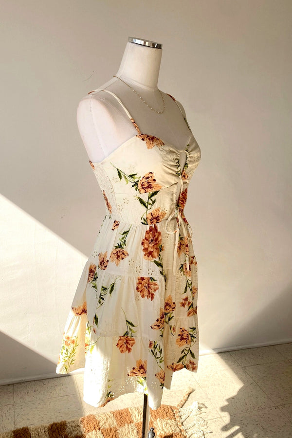 Floral dress on a mannequin against a plain background