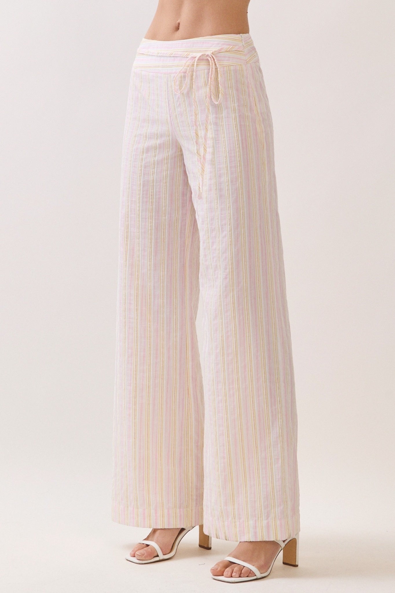Striped pants worn by a person on a white background