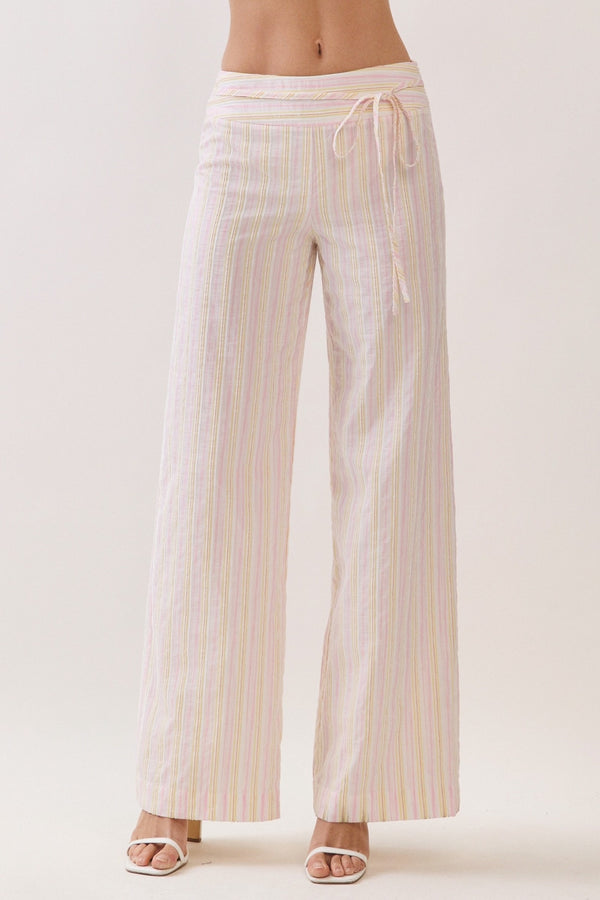 Striped pants worn by a person on a white background