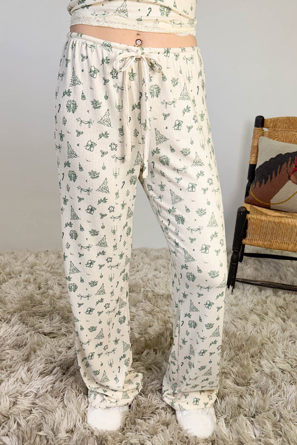 Floral patterned pajama set on a textured surface with a chair and cushion in the background.