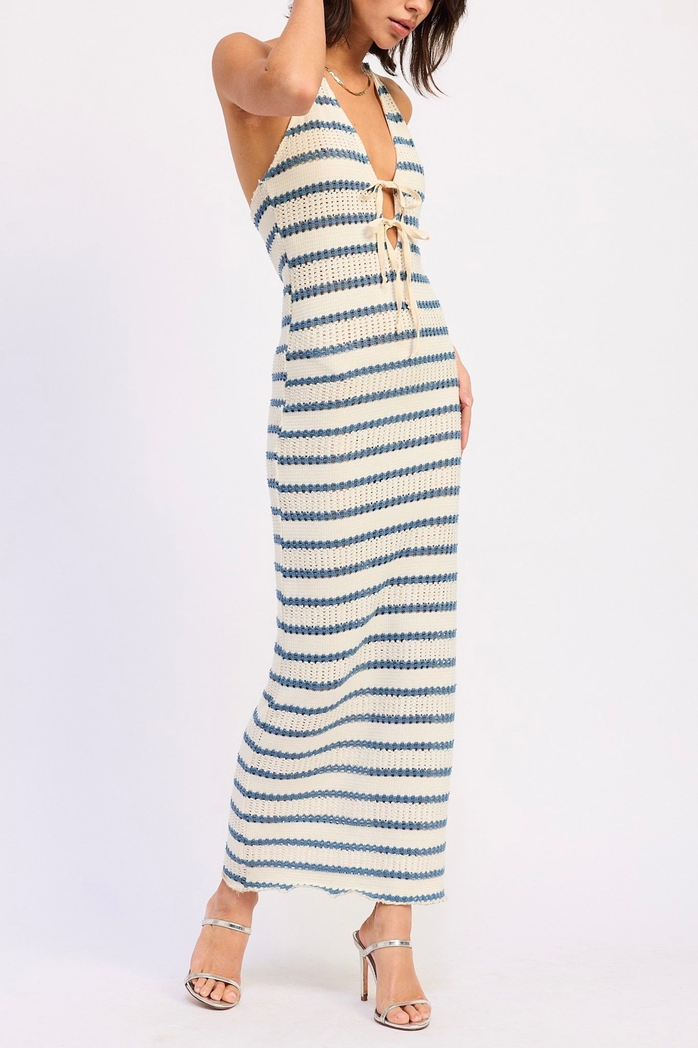 Woman wearing a striped dress on a white background