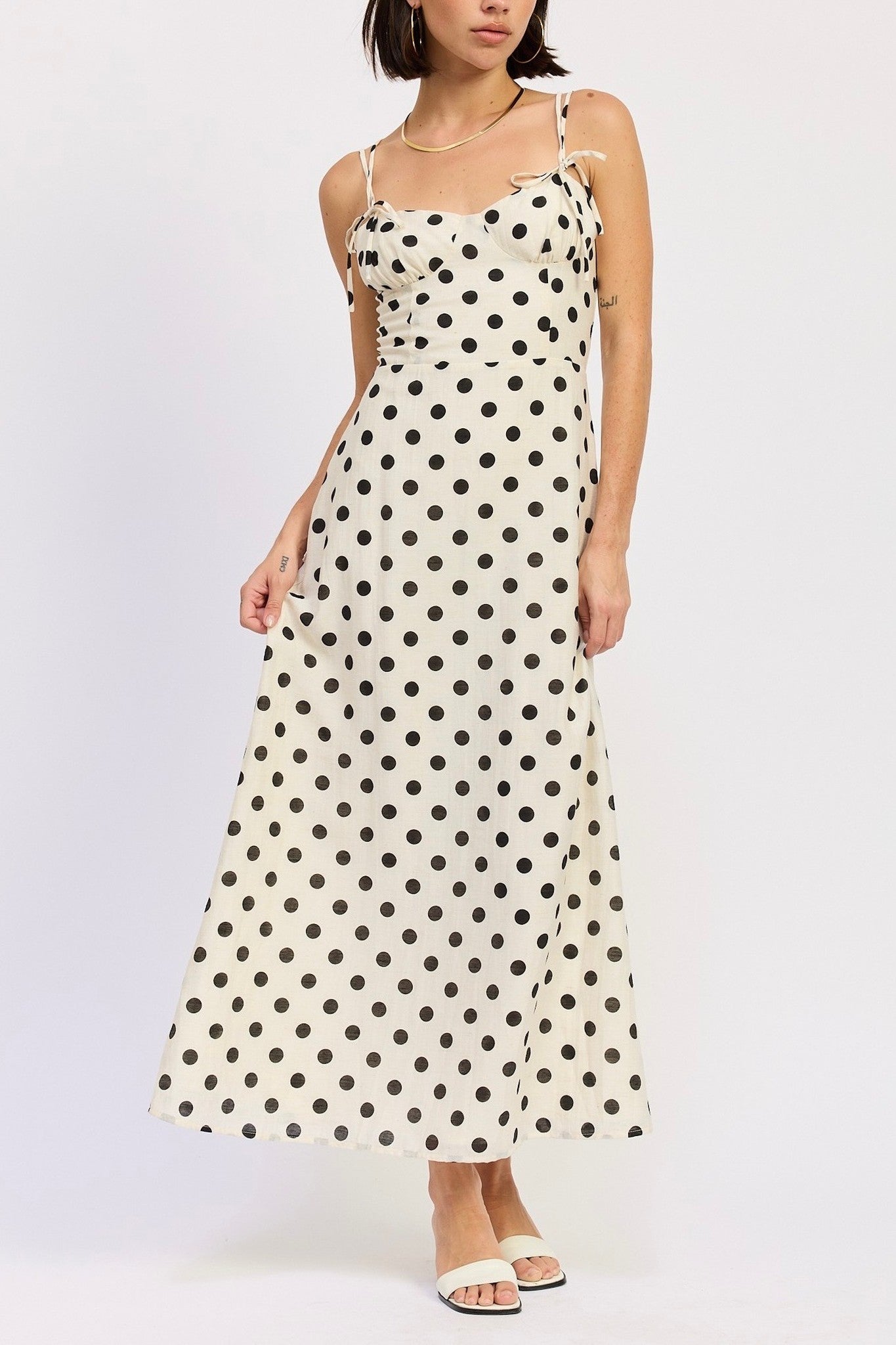 Woman wearing a polka dot dress on a white background