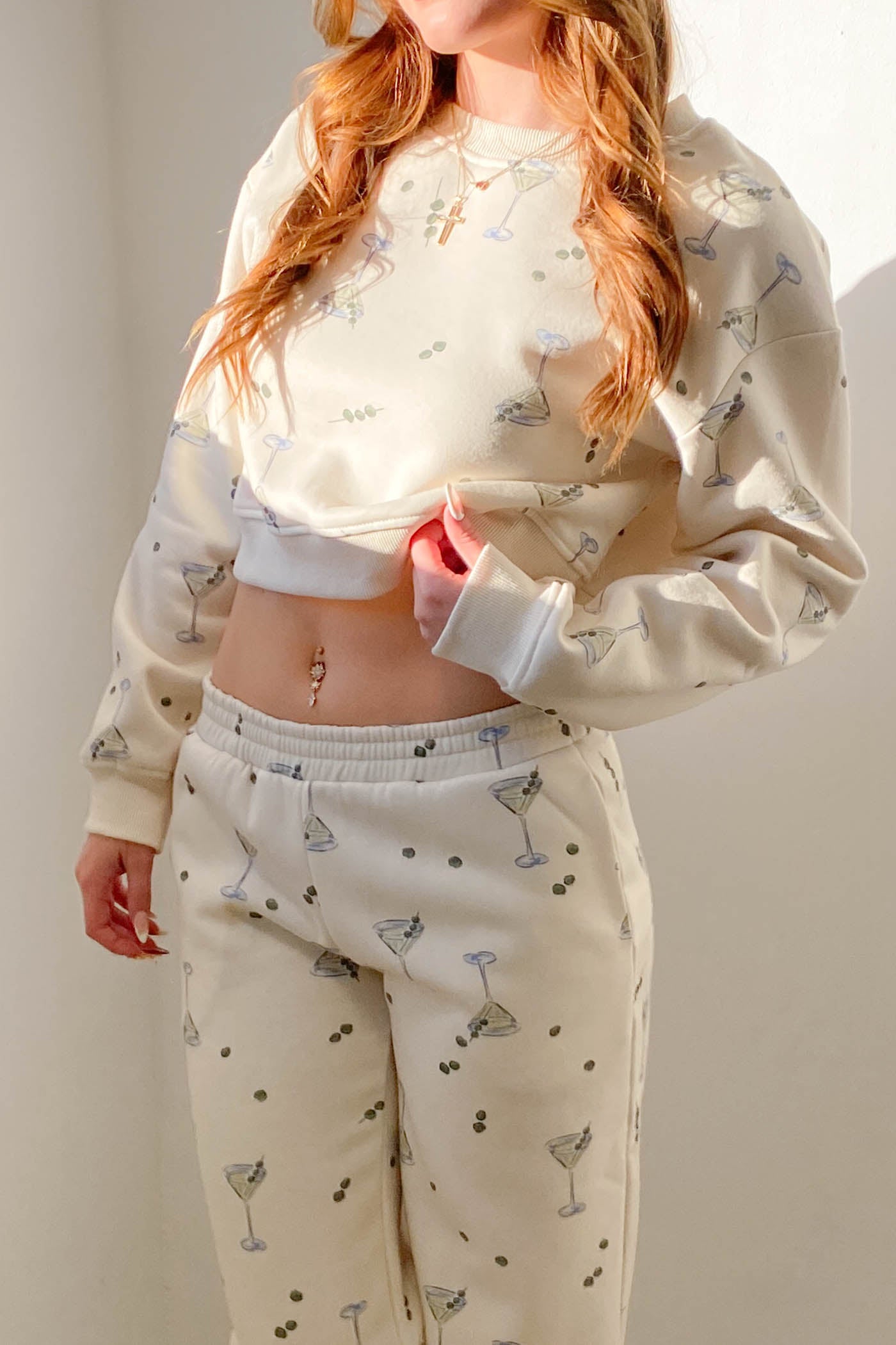 Person wearing a cream-colored pajama set with small patterns against a plain background