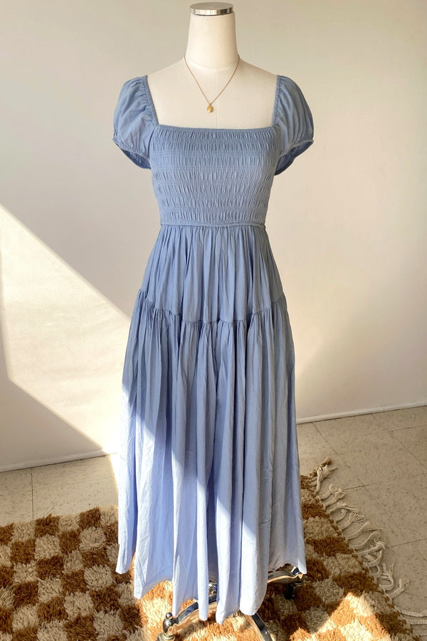 Blue dress on a mannequin against a neutral background
