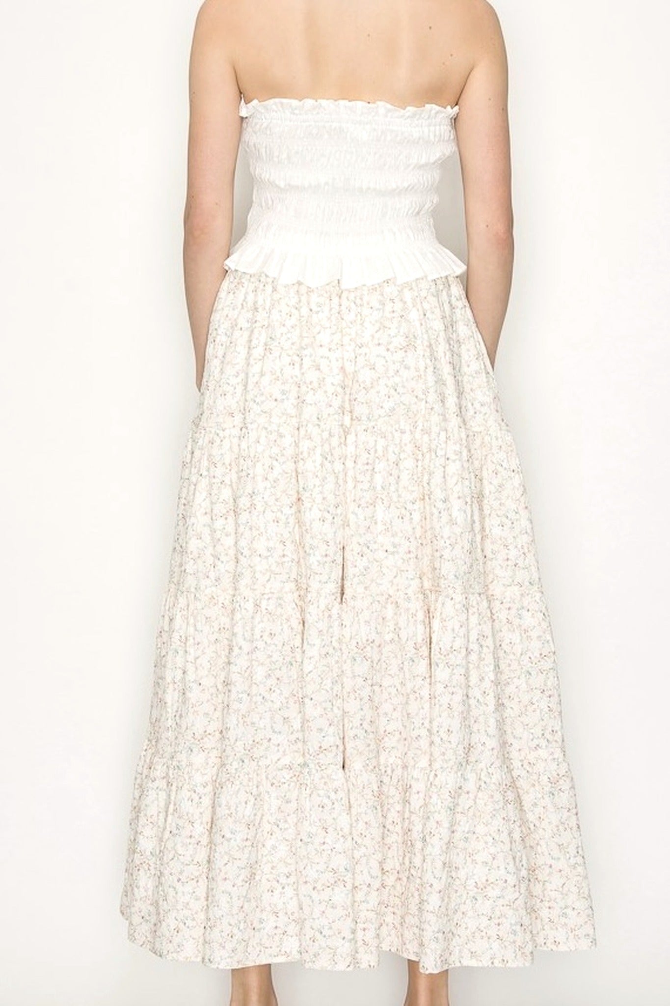 Cream Floral Midi Skirt on Model Standing against blank wall. 