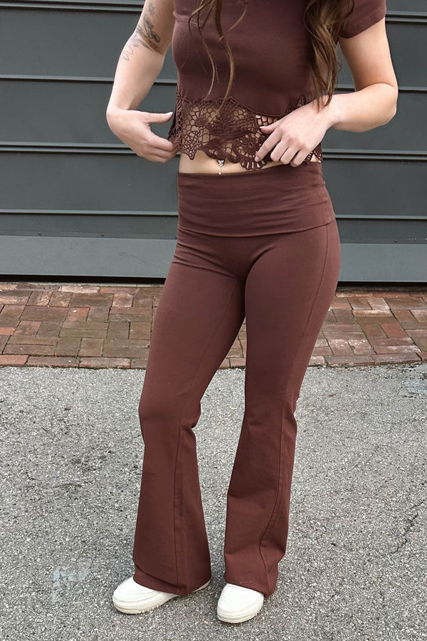 Person wearing a brown outfit with lace detailing in an outdoor setting