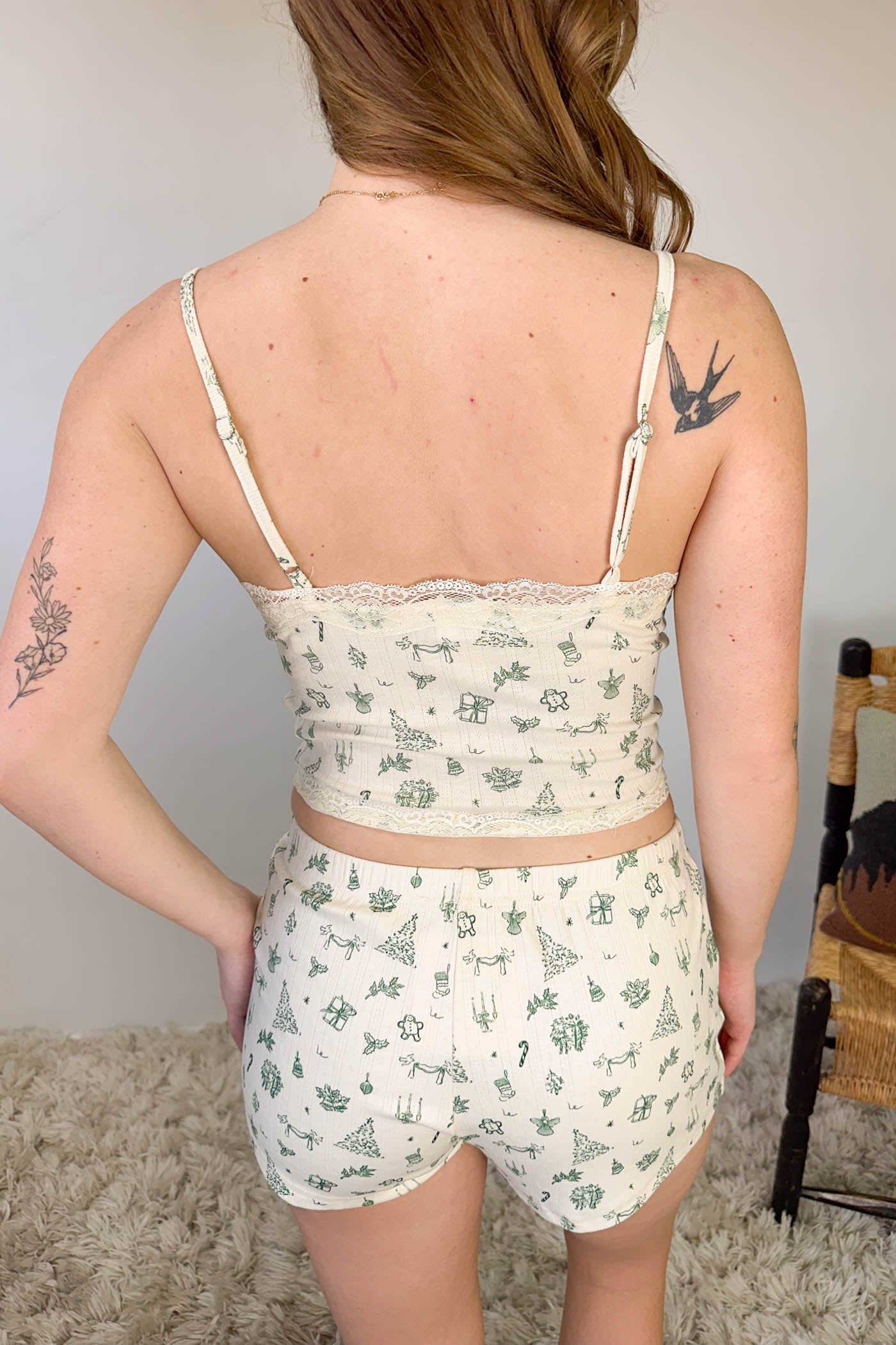 Person wearing a floral top and shorts set with a neutral background