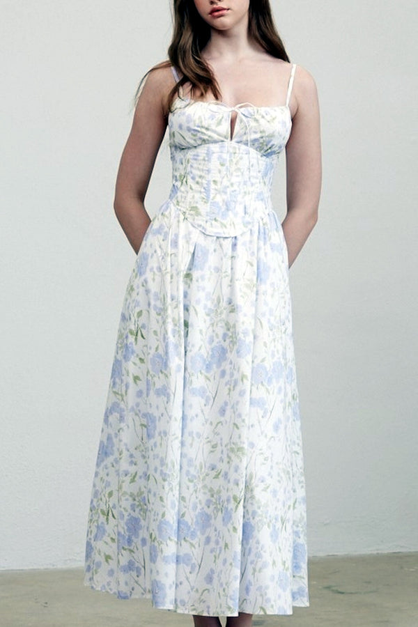 Woman wearing a floral dress against a plain background
