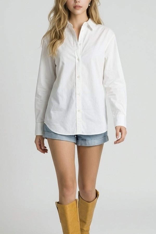 Person wearing a white button-up shirt, denim shorts, and yellow boots on a plain background